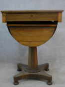 A mid 19th century rosewood sewing table with slide out baize lined work surface and basket