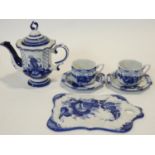 A Russian Gzhel blue and white glazed ceramic two person coffee set with hand painted floral