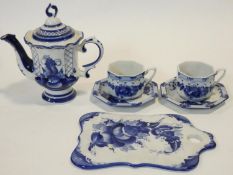 A Russian Gzhel blue and white glazed ceramic two person coffee set with hand painted floral