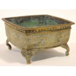 An 18th/19th century Chinese brass engraved square planter on four animal head feet. The sides of
