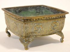 An 18th/19th century Chinese brass engraved square planter on four animal head feet. The sides of