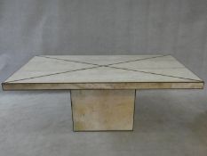 A brass bound travertine marble dining table on pedestal base. H.74 W.181 L.90cm