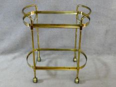 A vintage style brass serving trolley with two inset glass tiers. H.76 L.72 W.43cm