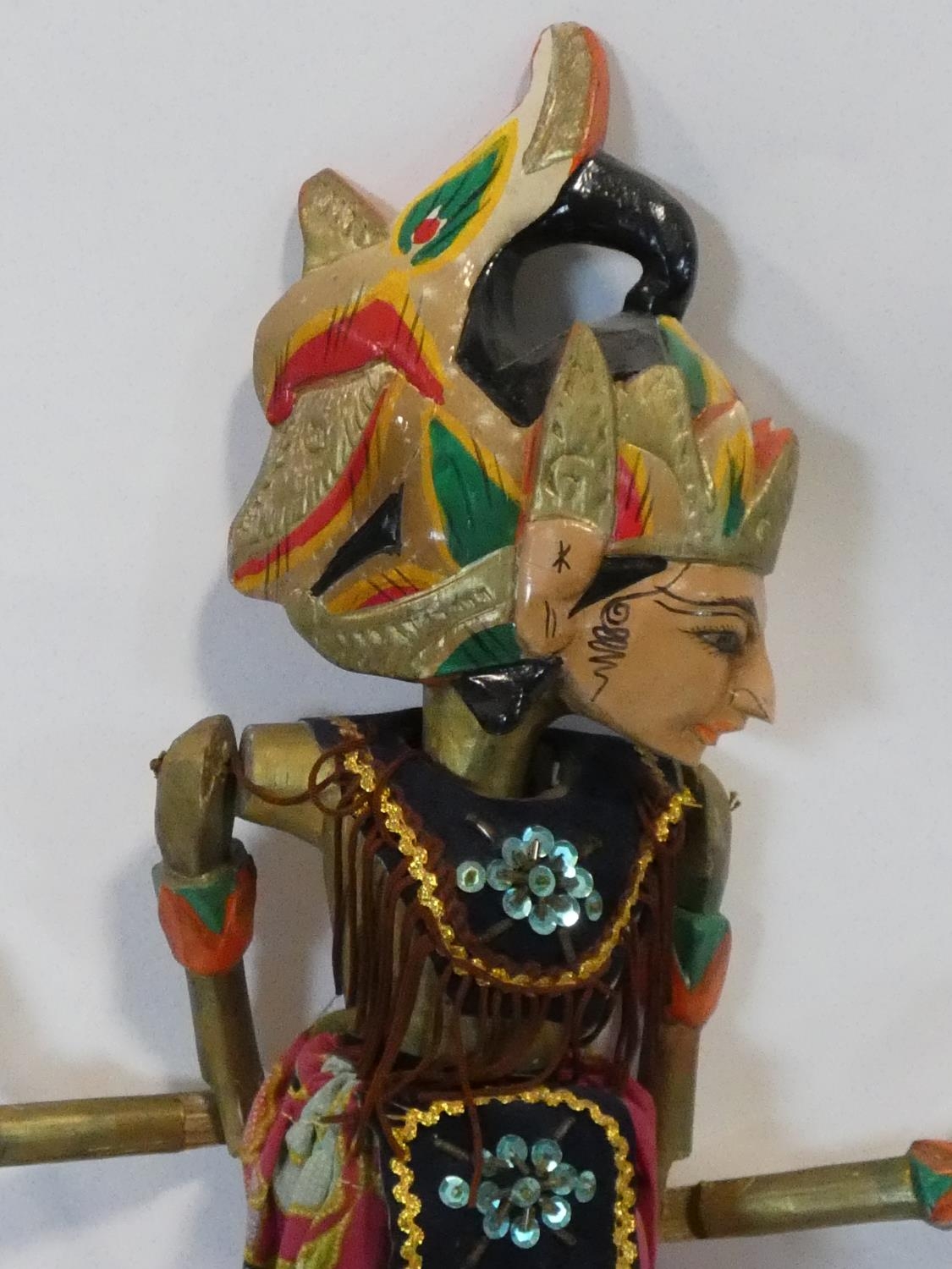 A painted Indonesian stick puppet and a carving of a child seated on a tree stump. H.51cm - Image 3 of 7