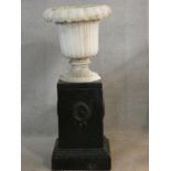 A painted reconstituted stone floral design garden urn on plinth base. H.102 D.43cm