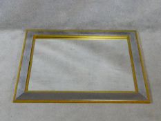 A contemporary wall mirror in glazed and gilt frame. H.70 W.90cm