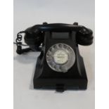 A 1960's G.P.O. bakelite telephone with pull out phone book section, rewired. H.15 W.24 D.18cm