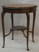 An Edwardian mahogany occasional table with gadrooned edges to the top and undertier raised on