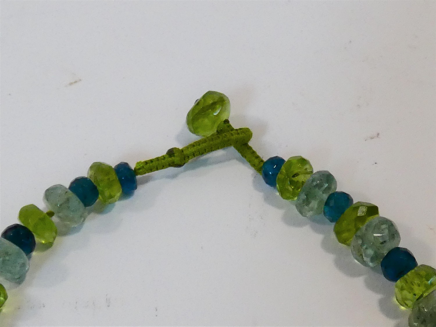 A bespoke faceted Apatite, Aquamarine and Peridot bead necklace with a silk chord loop clasp. L.42cm - Image 3 of 4