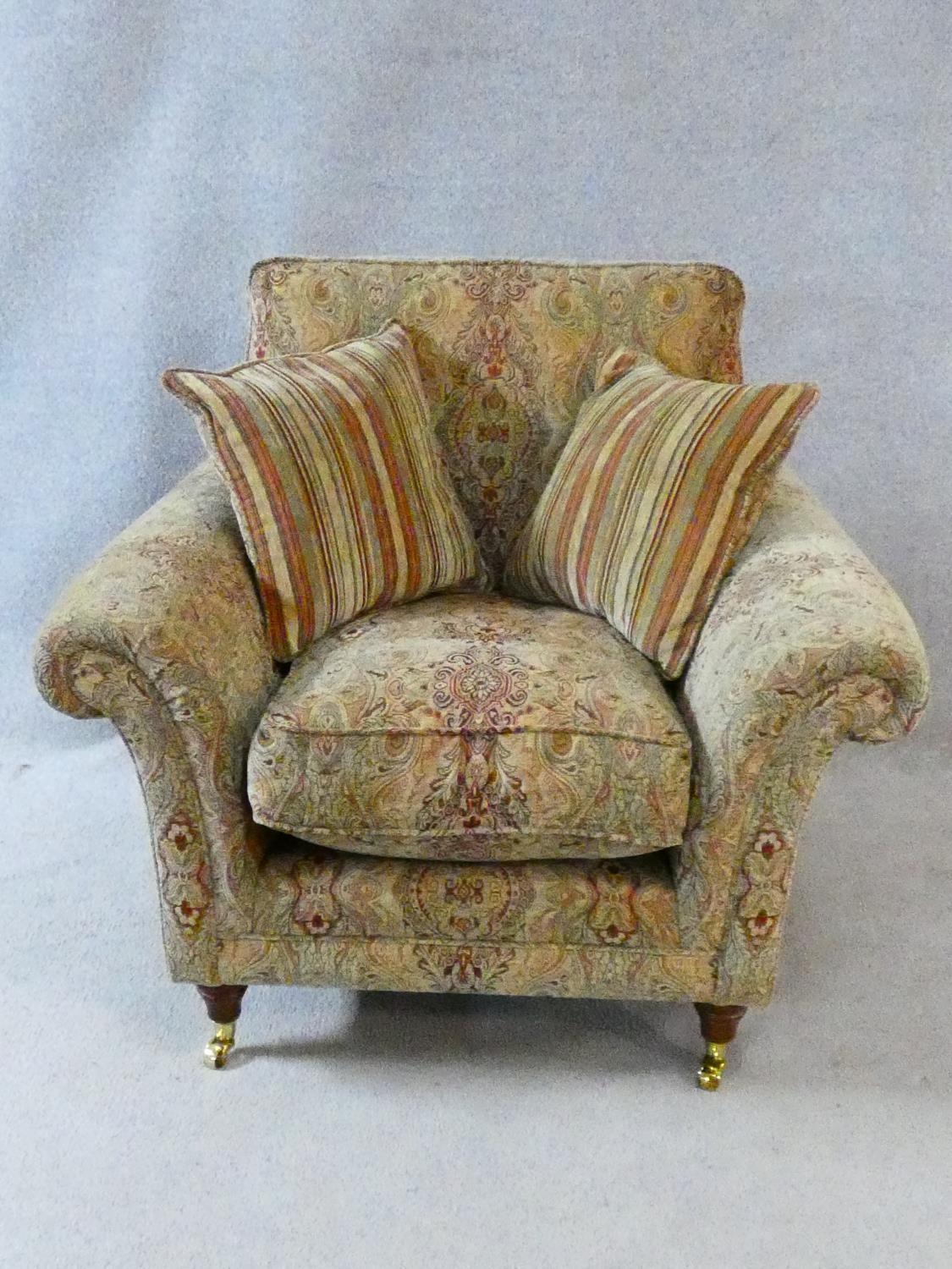A Parker Knoll Burghley armchair in Baslow Medalli gold upholstery raised on turned tapering - Image 2 of 3