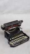 Corona black enamel metal typewriter inscribed L C Smith & Corona Typewriters Inc, in carrying case.