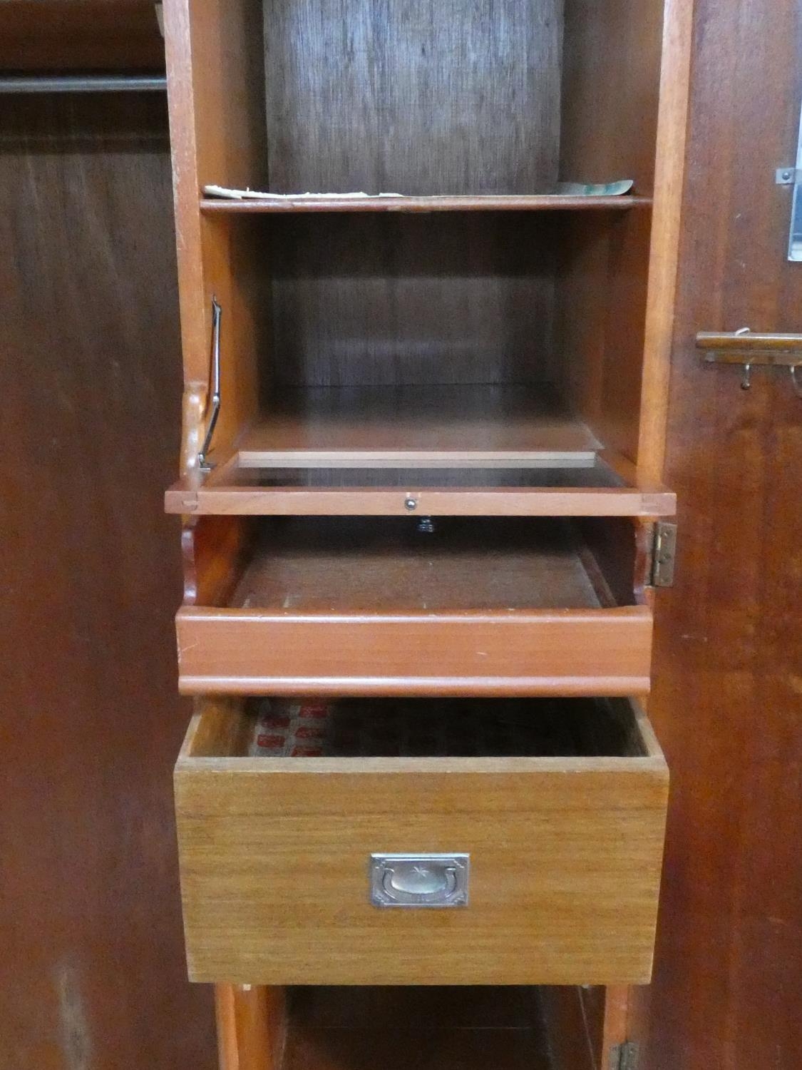 A 1960's fitted teak compactum wardrobe with inset Heal's disc to the inside of door. H.178 W.92 D. - Image 5 of 12