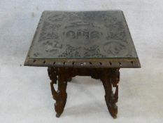 An Eastern hardwood occasional table with all over profuse figural, animal and foliate carving. H.65