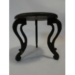 A small Indian hardwood occasional table with carved top and cabriole supports. H.30 D.30cm