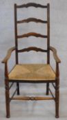 A 19th century oak Lancashire ladderback armchair. H.112cm