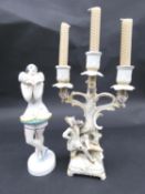 A Meissen style hand painted porcelain three branch candelabra, with dandy sitting at the bottom