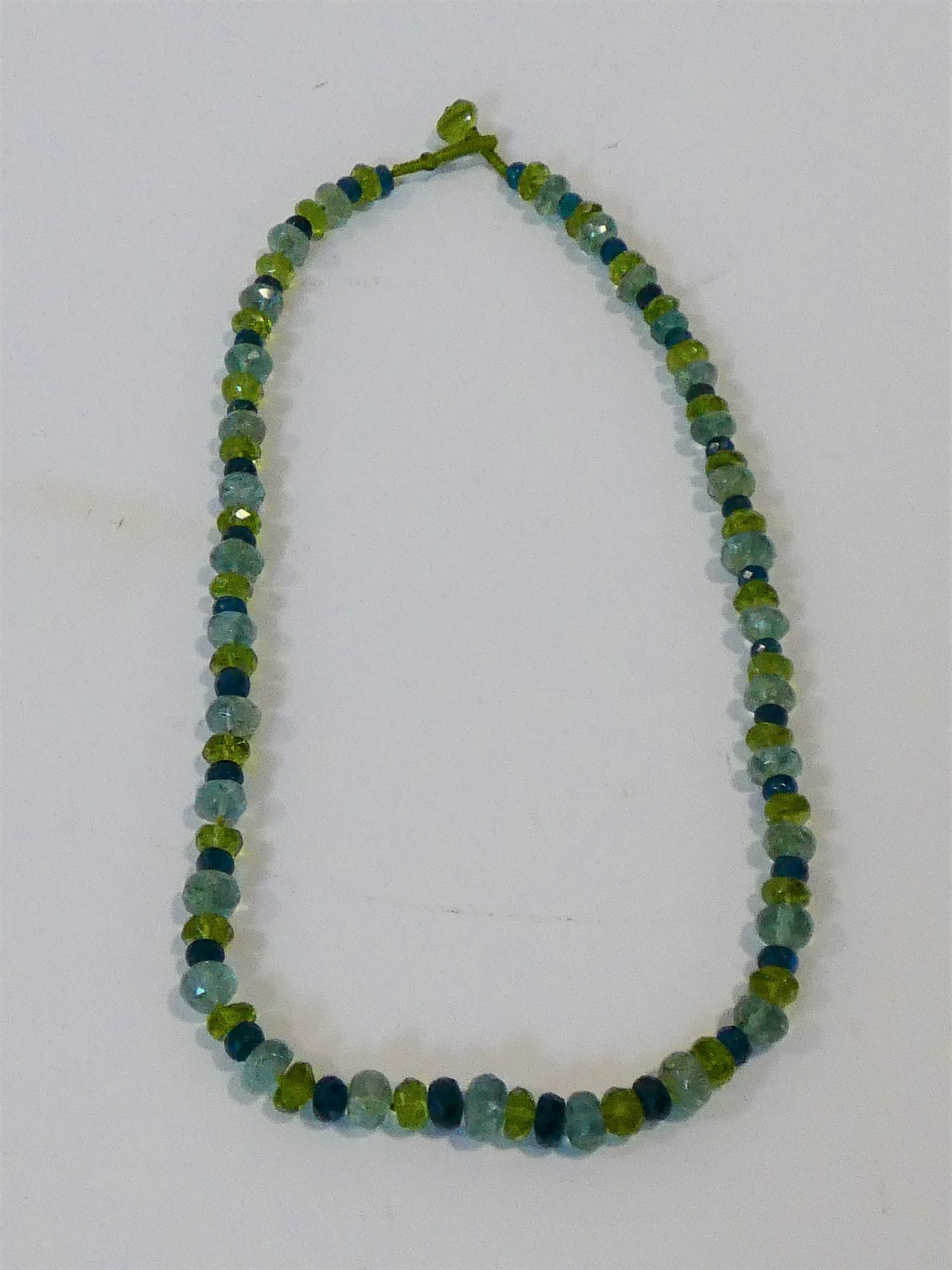 A bespoke faceted Apatite, Aquamarine and Peridot bead necklace with a silk chord loop clasp. L.42cm - Image 2 of 4