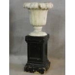 A painted reconstituted stone floral design garden urn on plinth base. H.101 D.44cm