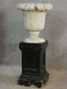 A painted reconstituted stone floral design garden urn on plinth base. H.101 D.44cm
