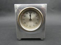 Liberty & Co Tudric pewter carriage clock. The hammered case raised on four ball feet with