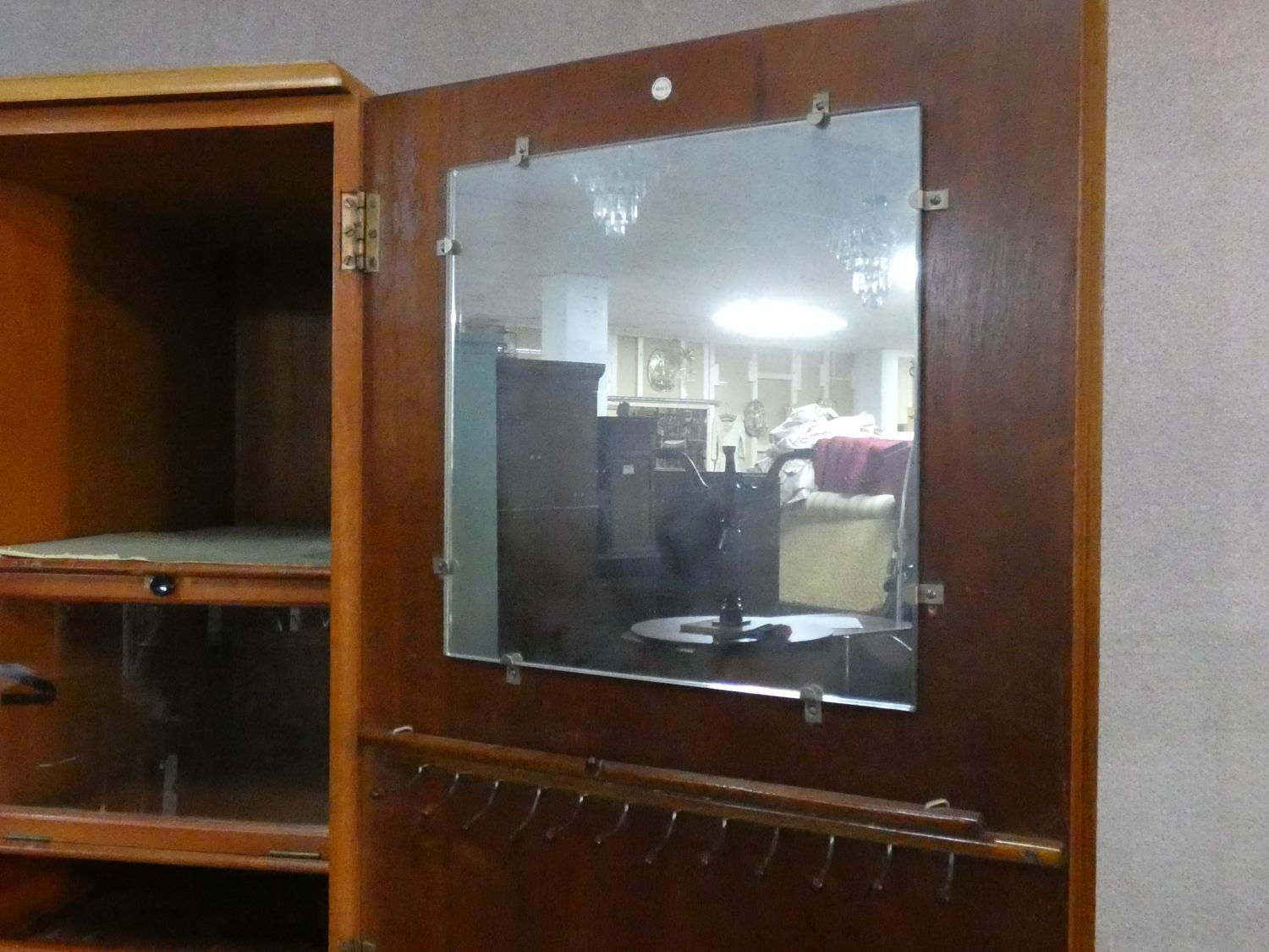 A 1960's fitted teak compactum wardrobe with inset Heal's disc to the inside of door. H.178 W.92 D. - Image 4 of 12