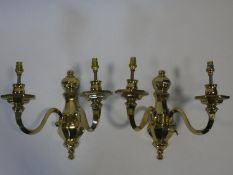 A pair of heavy solid brass Dutch style two branch wall candelabras with Bakelite collars. H.31cm.