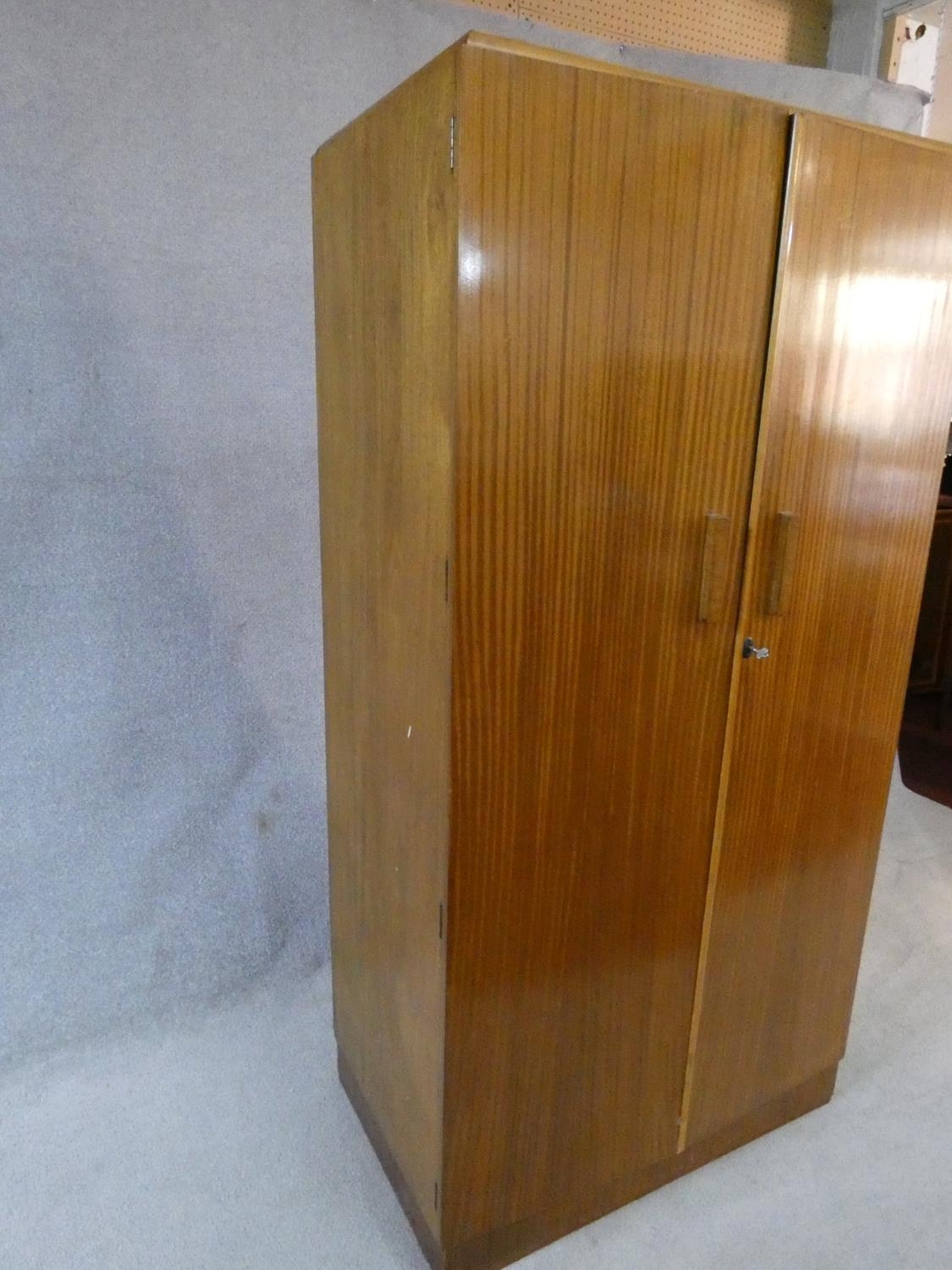 A 1960's fitted teak compactum wardrobe with inset Heal's disc to the inside of door. H.178 W.92 D. - Image 11 of 12