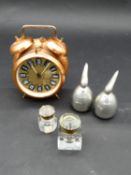 A vintage copper cased twin bell alarm clock, designer aluminium salt and pepper shakers and two