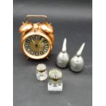 A vintage copper cased twin bell alarm clock, designer aluminium salt and pepper shakers and two