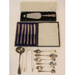 A collection of antique and vintage silver cutlery. Including Georgian sugar tongs and sauce