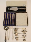 A collection of antique and vintage silver cutlery. Including Georgian sugar tongs and sauce