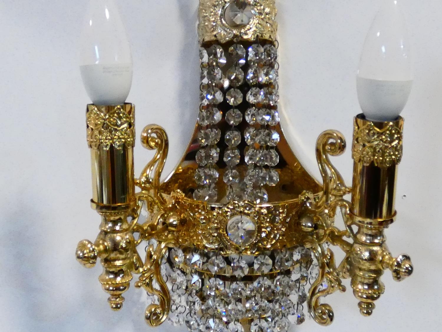 A set of six gilt metal twin branch wall candelabras with crystal drops. H.38cm - Image 4 of 9