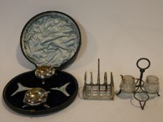 A collection of antique silver. Including a pair of cased silver salts, a silver toast rack and a