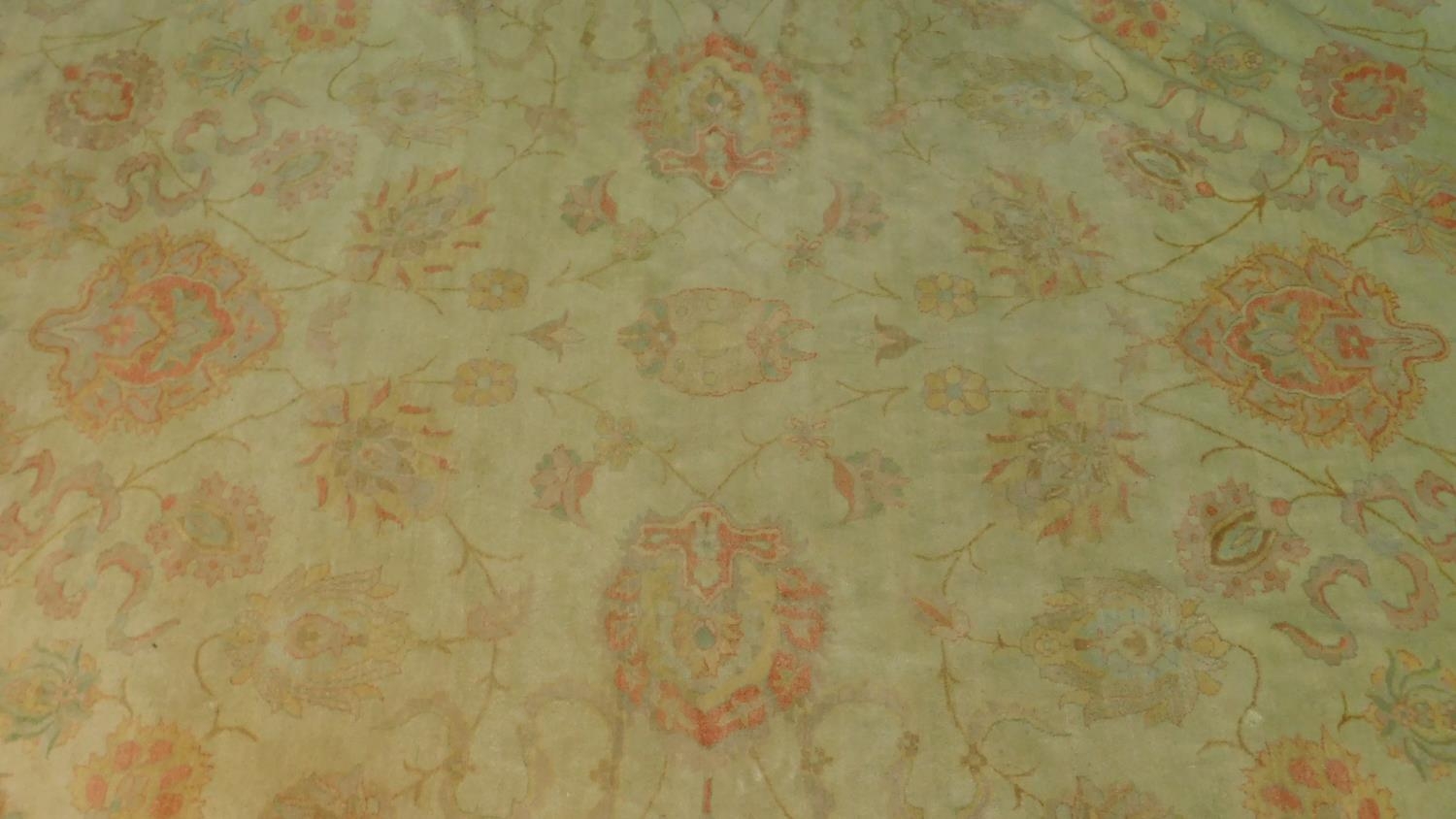 A large Ziegler style carpet with all over scrolling vine, palmette and floral decoration to the - Image 2 of 4