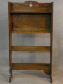 An vintage oak open bookcase with fret cut decoration on platform feet. H.116 W.62 D.23cm