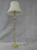 A heavy solid brass standard lamp and shade. H.165cm