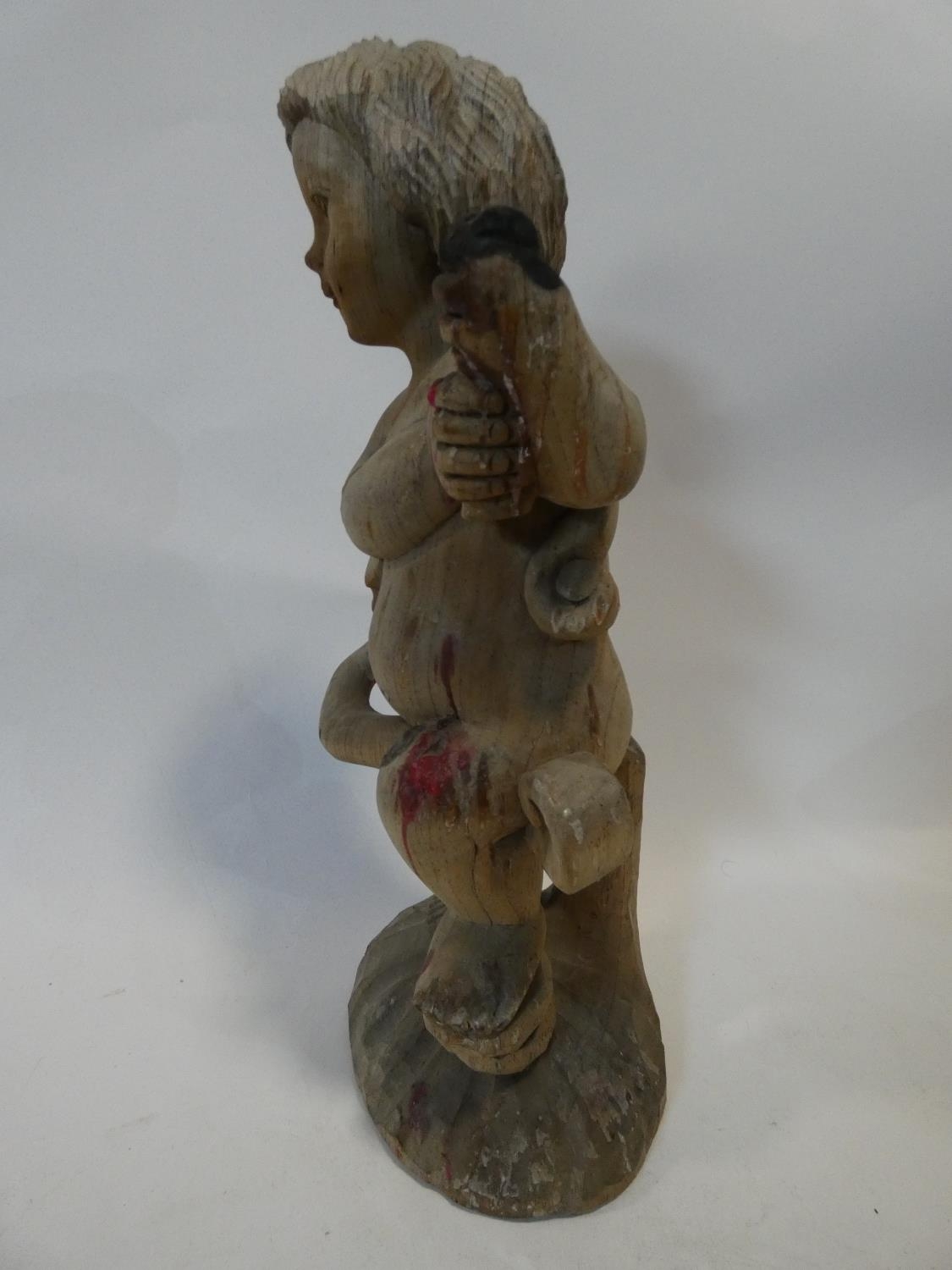 A painted Indonesian stick puppet and a carving of a child seated on a tree stump. H.51cm - Image 5 of 7