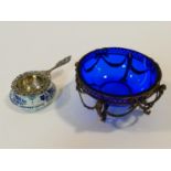A Dutch repousse floral design pierced silver tea strainer with white and blue ceramic bowl, along
