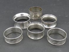 A collection of silver napkin rings. Two with a pierced Greek key design, hallmarked: HG&S for Henry