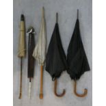 A collection of antique umbrellas and parasols. H.93cm