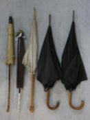 A collection of antique umbrellas and parasols. H.93cm