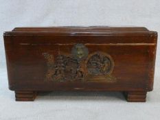 A mid century Chinese carved camphorwood trunk with inset carved carrying handles. H.41 W.77 D.37cm