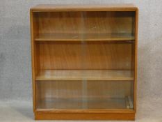 A vintage teak bookcase with sliding glass doors. H.75 W.68 D.27cm