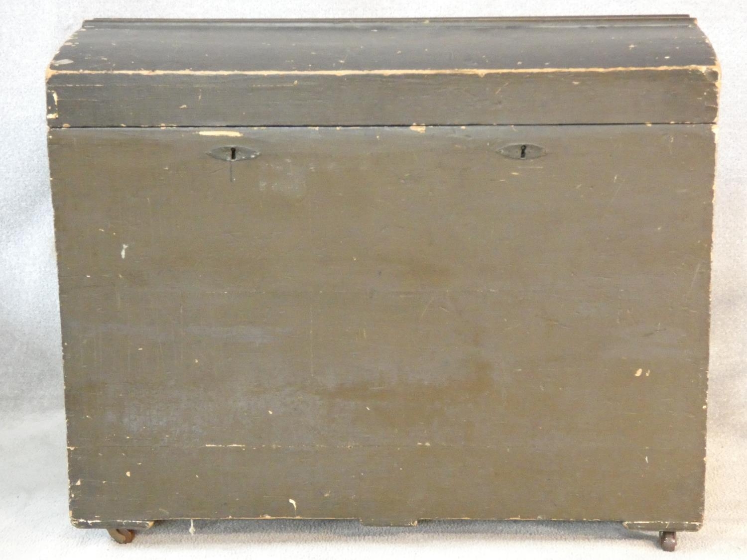 A 19th century domed top travelling trunk on casters. H.88 L.107 W.60cm