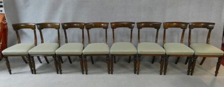 A set of eight William IV mahogany dining chairs with acanthus carving to the backs raised on