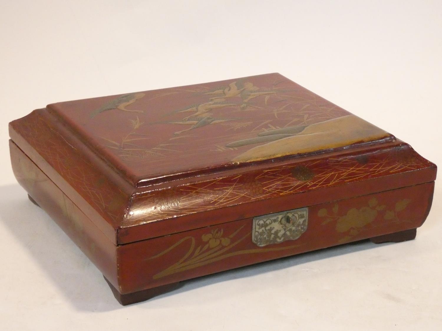 An antique Japanese lacquered fitted gaming box with hand painted gilt decoration depicting a