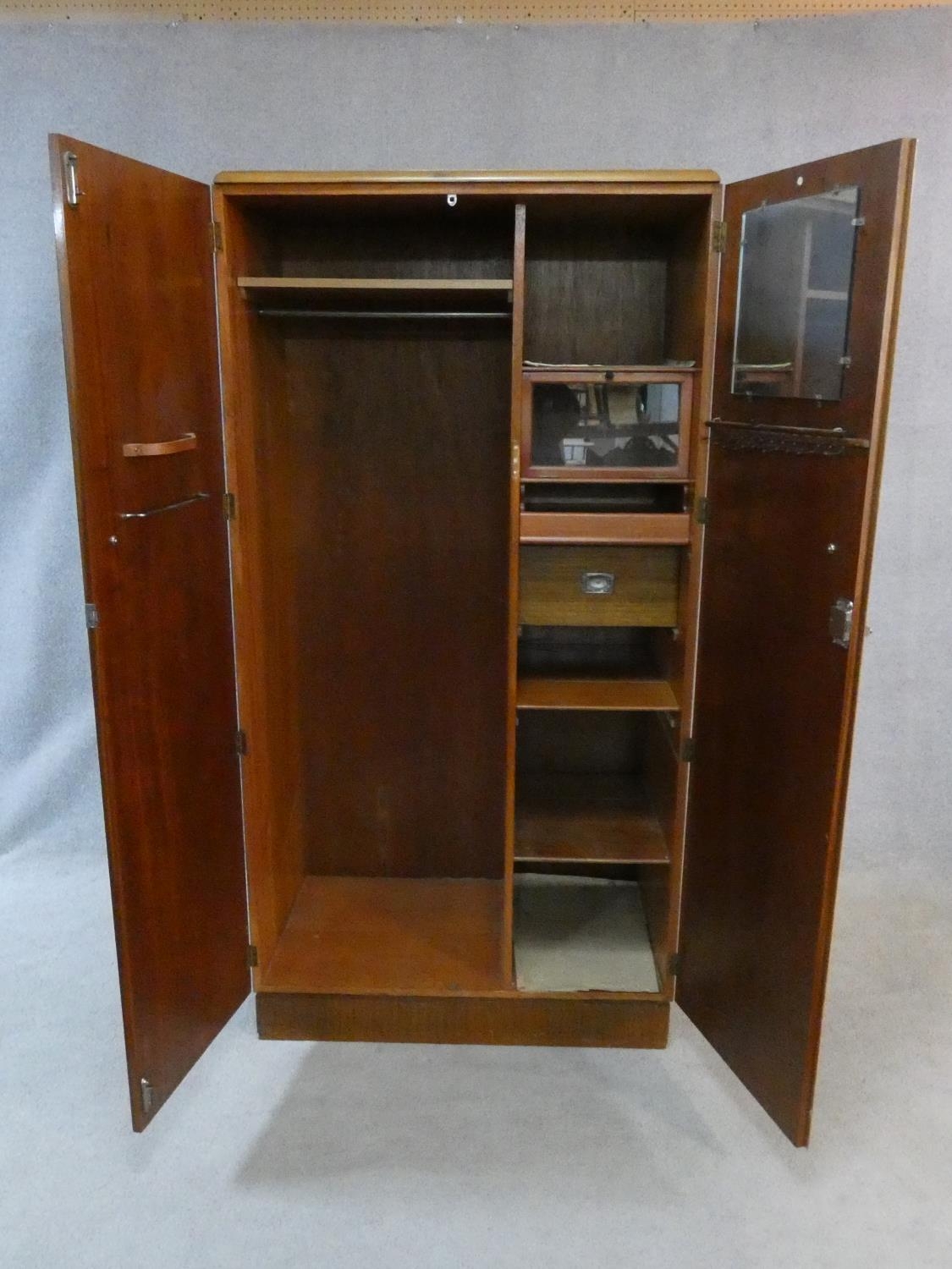 A 1960's fitted teak compactum wardrobe with inset Heal's disc to the inside of door. H.178 W.92 D. - Image 2 of 12