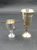 Two antique silver trophy cups. One with twin handles, hallmarked JG Ltd for Joseph Gloster Ltd,