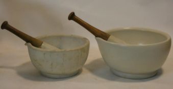 A large 19th century apothecary's ceramic mortar and pestle and another similar, stamped Made in