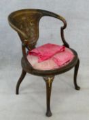 A late 19th century mahogany tub armchair with satinwood and ivory inlay on cabriole supports. H.